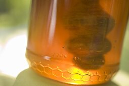 Jar of honey with honey dipper