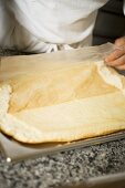 Pulling baking parchment off sponge base