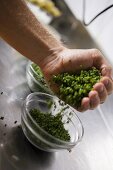 Putting chopped chives into bowl