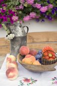 Summer fruit still life on table in front of house