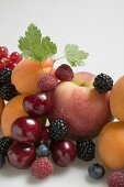 Fruit still life with stone-fruit, berries & leaves (detail)