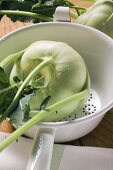 Kohlrabi with drops of water in colander