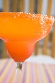 Margarita in orange glass with salted rim