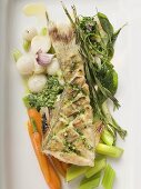 Fried sea bass with pesto on vegetables