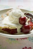 Piece of cherry pie with vanilla ice cream & fresh cherries (USA)