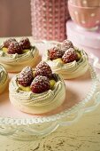 Meringue shells with raspberries, vanilla cream & icing sugar