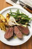 Beef steak with potato wedges, spring onion, beans & bacon
