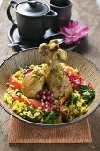 Chicken legs with saffron rice & pomegranate seeds (Asia)