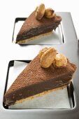 Two pieces of chocolate tart with almonds on tray