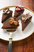 Four pieces of chocolate tart with different decorations