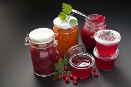 A selection of jams & jelly in jars, redcurrants & leaves