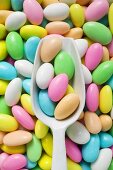 Sugared almonds, some in scoop