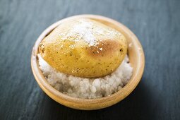 Salted baked potato in dish of salt