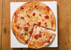 Pizza Margherita, a slice cut, on pizza box
