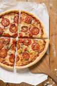 Cheese and tomato pizza with oregano (quartered)