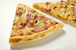 Slices of American-style ham and mushroom pizza