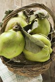 Fresh quinces with leaves in a basket