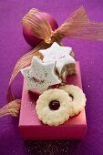 Cinnamon stars and jam biscuits on pink box