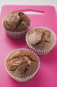 Three chocolate and vanilla muffins in paper cases