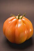 Tomato on brown background