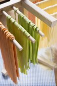 Home-made ribbon pasta, hanging up to dry