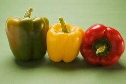 Three peppers (yellow, red, green) in a row