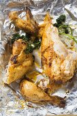 Pieces of roast chicken in aluminium foil