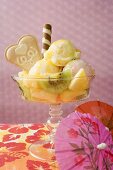 Ice cream sundae with fresh fruit, cocktail umbrella
