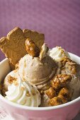 Nut ice cream with caramelised nuts, cream and cookies