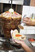 Sprinkling seasoning on a döner kebab