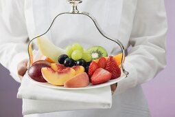 Waitress serving a plate of fruit