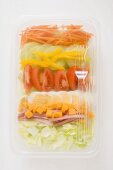 Iceberg lettuce, ham, cheese, egg & vegetables in plastic tray