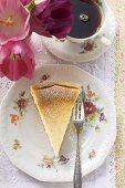 Piece of quark cake,  coffee and tulips (overhead view)