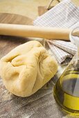 Pasta dough, olive oil and rolling pin