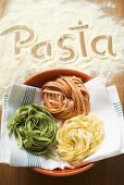 Home-made ribbon pasta and the word 'Pasta'