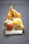 Three pears and an apple on cloth