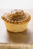 Meat pie on wooden surface