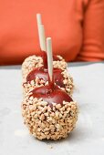 Toffee apples with chopped nuts