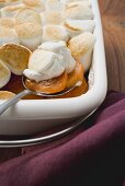 Sweet potato & marshmallow gratin in baking dish with spoon