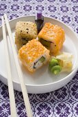 Inside-out rolls with soy sauce, ginger and wasabi