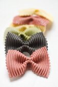 Coloured farfalle in a row