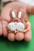 Child's hand holding marzipan Easter Bunny