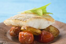 Fish fillet with fried potatoes and cherry tomatoes