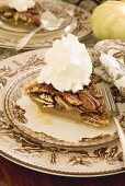 Piece of pecan pie with cream for Thanksgiving