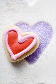 Biscuit on purple sugar in heart-shaped biscuit mould