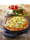 Tomato and mozzarella pizza with basil