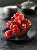 Small chocolate cake with raspberries to serve with tea