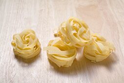 Tagliatelle on wooden background