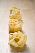 Tagliatelle on wooden background