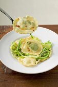 Ravioli with courgette laces on plate and fork